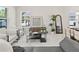 Stylish living room featuring modern furniture, a decorative mirror, and access to the dining area at 805 S Locust Ave, Sanford, FL 32771
