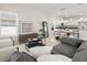 Bright, stylish living room with a view of the kitchen, modern furniture, and ample natural light at 805 S Locust Ave, Sanford, FL 32771
