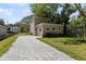 Back view of home with a long, paved driveway leading to garage at 805 S Locust Ave, Sanford, FL 32771