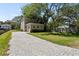 Back view of home with a long, paved driveway leading to garage at 805 S Locust Ave, Sanford, FL 32771