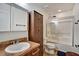 Bathroom with dark wood cabinet and bath/shower combo, complete with neutral tile floors at 8111 Pacific Loon St, Winter Garden, FL 34787