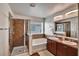 Bathroom featuring a glass shower, soaking tub, double sink vanity, and window at 8111 Pacific Loon St, Winter Garden, FL 34787