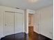 Bedroom featuring dark wood floors, a large closet, and neutral paint at 8111 Pacific Loon St, Winter Garden, FL 34787