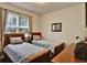 Cozy bedroom featuring two beds with wood frames, a large window, and a dresser at 8111 Pacific Loon St, Winter Garden, FL 34787