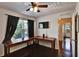 Bedroom with dark wood floors, desk, window and ceiling fan at 8111 Pacific Loon St, Winter Garden, FL 34787