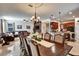 Open-concept dining room with tile floors, a large table, open to the living room and charming kitchen at 8111 Pacific Loon St, Winter Garden, FL 34787