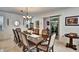 Elegant dining room featuring tile floors, decorative mirror, and a large wooden table with seating for ten at 8111 Pacific Loon St, Winter Garden, FL 34787