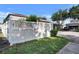 View of the white lattice fence with landscaping along the property and long driveway leading to the garage at 8111 Pacific Loon St, Winter Garden, FL 34787