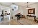 Bright foyer with tile floors, grand piano, elegant console table, and a view of the staircase at 8111 Pacific Loon St, Winter Garden, FL 34787
