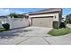 Exterior view of the two car garage and large concrete driveway at 8111 Pacific Loon St, Winter Garden, FL 34787