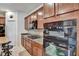 Kitchen featuring modern built-in oven, gas range, and dark wood cabinetry at 8111 Pacific Loon St, Winter Garden, FL 34787