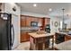 Functional kitchen with dark wood cabinetry, a center island, modern appliances, and tile flooring at 8111 Pacific Loon St, Winter Garden, FL 34787