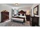 The main bedroom features hardwood floors, a large bed, and dark wood furniture at 8111 Pacific Loon St, Winter Garden, FL 34787