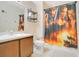 Standard bathroom featuring a sink, toilet, and shower with a Pirates of the Caribbean themed shower curtain at 847 Coventry Rd, Davenport, FL 33897