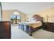 Large bedroom with vaulted ceiling, a window with a view, and a dark wood bed set at 847 Coventry Rd, Davenport, FL 33897