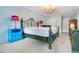 Charming bedroom with ornate bed, blue side tables, and a view to the hallway at 847 Coventry Rd, Davenport, FL 33897