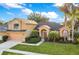 Charming two-story home with landscaped yard, mature palms, and attached two-car garage at 847 Coventry Rd, Davenport, FL 33897