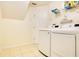 Efficient laundry room featuring modern washer and dryer, ample storage shelves, and convenient access at 847 Coventry Rd, Davenport, FL 33897