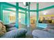 Open-concept living room offers abundant space with teal columns and gray sofas for relaxation and entertaining at 847 Coventry Rd, Davenport, FL 33897