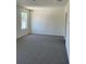 Neutral bedroom with carpet flooring and a window for natural light at 978 Commons Way, Port Orange, FL 32129