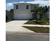 Charming two-story home with a well-manicured lawn and a two-car garage at 978 Commons Way, Port Orange, FL 32129