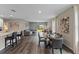 Open-concept living and dining area featuring stylish decor, hardwood floors, and natural light at 978 Commons Way, Port Orange, FL 32129