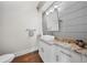Stylish half bath with modern vanity, granite countertop, and shiplap accent wall at 984 Fern Ave, Orlando, FL 32814