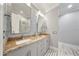 Elegant bathroom boasts granite countertops, double sinks, and wood-look tile floors at 984 Fern Ave, Orlando, FL 32814