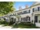 This townhome has black shutters, a well-manicured lawn, dormer windows, and a welcoming entrance at 984 Fern Ave, Orlando, FL 32814