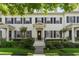 Charming two-story townhome with black shutters, a well-manicured lawn, and a welcoming entrance at 984 Fern Ave, Orlando, FL 32814