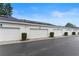 Row of attached garages with well-maintained landscaping and a paved driveway at 984 Fern Ave, Orlando, FL 32814