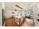 Kitchen open concept with an island with sink, pendant lights, stainless appliances, and a dining area at 984 Fern Ave, Orlando, FL 32814
