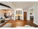 Open living space with wood floors, a bar area, and views of the dining room and stairs at 984 Fern Ave, Orlando, FL 32814