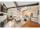 Living room with beams, shiplap, fireplace, wood floors and staircase to the second floor at 984 Fern Ave, Orlando, FL 32814