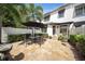Private patio with a neutral paver patio, trimmed bushes, and outdoor seating at 984 Fern Ave, Orlando, FL 32814