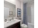 Cozy bathroom with a shower-tub combo, vanity, and modern fixtures at 989 Commons Way, Port Orange, FL 32129