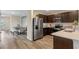 Spacious kitchen with stainless appliances, dark cabinetry, and a dining area at 989 Commons Way, Port Orange, FL 32129