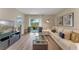 Bright living room with a modern sofa and sliding glass doors to the outdoors at 989 Commons Way, Port Orange, FL 32129