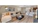Bright open-concept living room with modern decor, stylish furniture, and adjacent kitchen area at 989 Commons Way, Port Orange, FL 32129