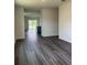 Open-concept living area with modern gray flooring and abundant natural light from the backyard sliding glass door at 989 Commons Way, Port Orange, FL 32129