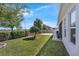Serene backyard featuring a green lawn, mature trees, and a paved patio area for outdoor enjoyment at 16238 Misty Hills Ave, Winter Garden, FL 34787