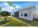 Well-kept backyard featuring a manicured lawn, a paved patio, and mature landscaping for privacy at 16238 Misty Hills Ave, Winter Garden, FL 34787
