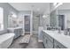 Spa-like bathroom with soaking tub, dual vanities, and a glass enclosed walk-in shower at 16238 Misty Hills Ave, Winter Garden, FL 34787