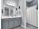 Neutral bathroom with double sinks, white countertop, and shower/tub combo at 16238 Misty Hills Ave, Winter Garden, FL 34787