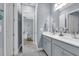 Neutral bathroom with double sinks, white countertop, and adjoining office at 16238 Misty Hills Ave, Winter Garden, FL 34787