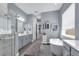 A luxurious bathroom features a modern tub, double vanity, and walk-in shower at 16238 Misty Hills Ave, Winter Garden, FL 34787