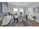 Bright dining room features a glass table, chandelier, and chic decor with backyard views at 16238 Misty Hills Ave, Winter Garden, FL 34787