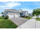Beautiful one-story home with a brick driveway, two-car garage, manicured lawn, and elegant landscaping at 16238 Misty Hills Ave, Winter Garden, FL 34787