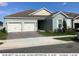 Charming single-story home features a two-car garage, brick driveway, and well-maintained landscaping at 16238 Misty Hills Ave, Winter Garden, FL 34787