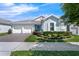 Attractive home with a two-car garage, brick driveway, beautiful landscaping, and a covered entryway at 16238 Misty Hills Ave, Winter Garden, FL 34787